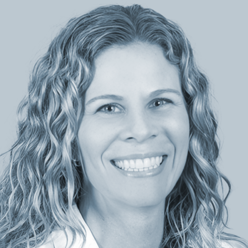 Smiling woman with curly hair in a head-and-shoulders portrait for a team page option B.